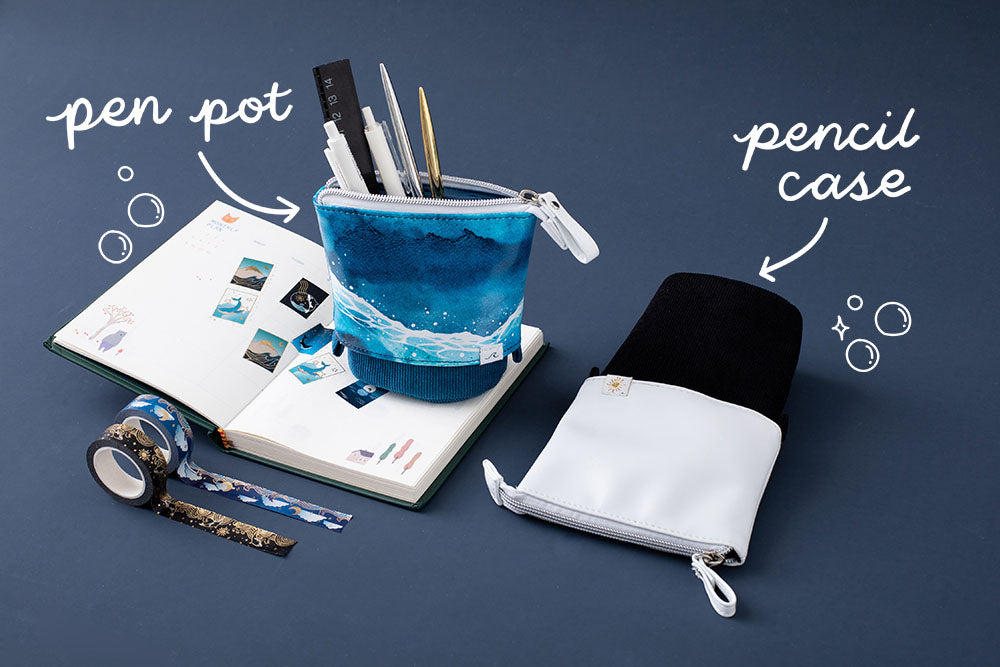 Tsuki Ocean Edition pop up standing pencil cases in Orca Black and Ocean Blue with Tsuki Ocean Washi Tape and open notebook and pen set in dark blue background