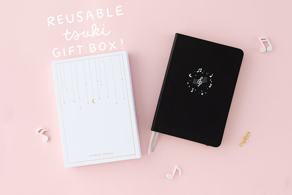 Tsuki Lunar Notes bullet journal with box packaging flat lay with reusable tsuki gift box doodle image on pink background