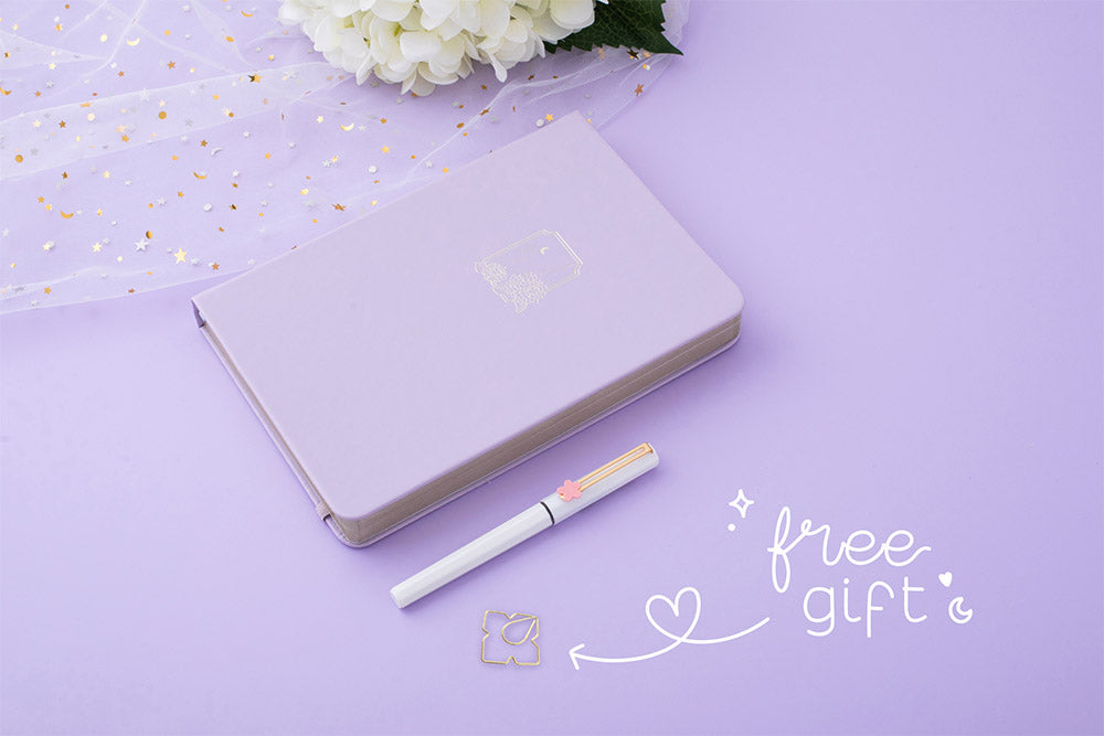 Tsuki Endless Summer Limited Edition Bullet Journal in Lilac Bloom with free gift with sparkly netting and white hydrangea flowers and pen on lilac background