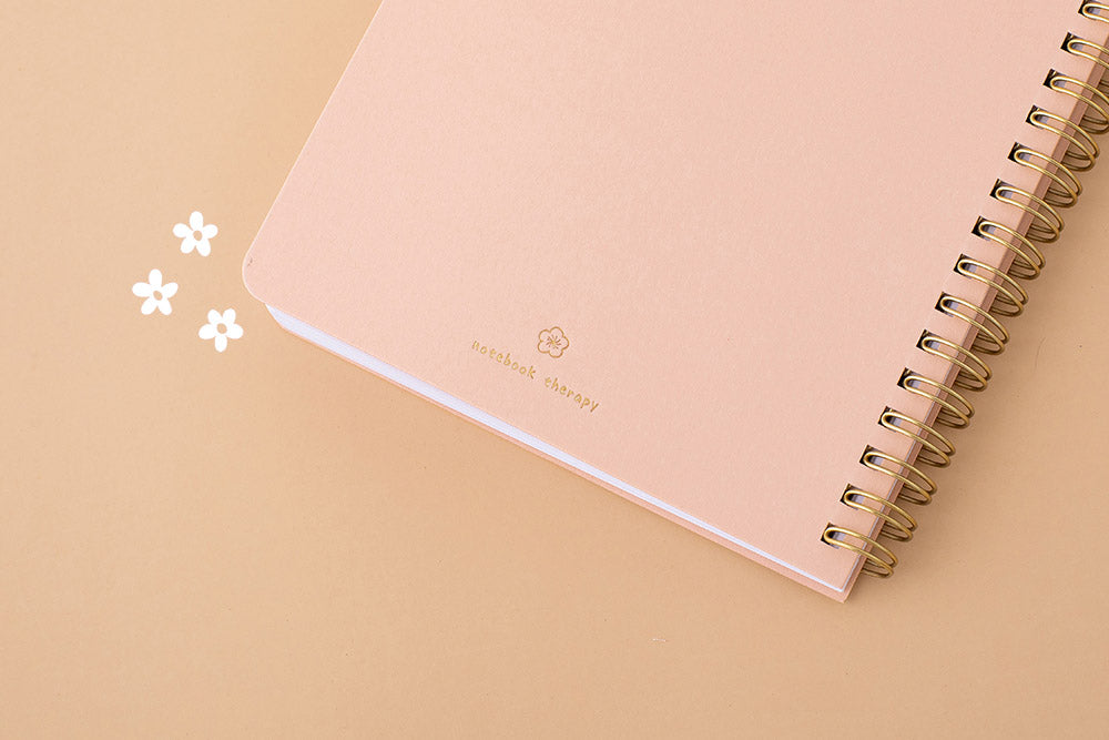 Close up of the back cover of Tsuki Floral honey peach ringbound bujo on peach background