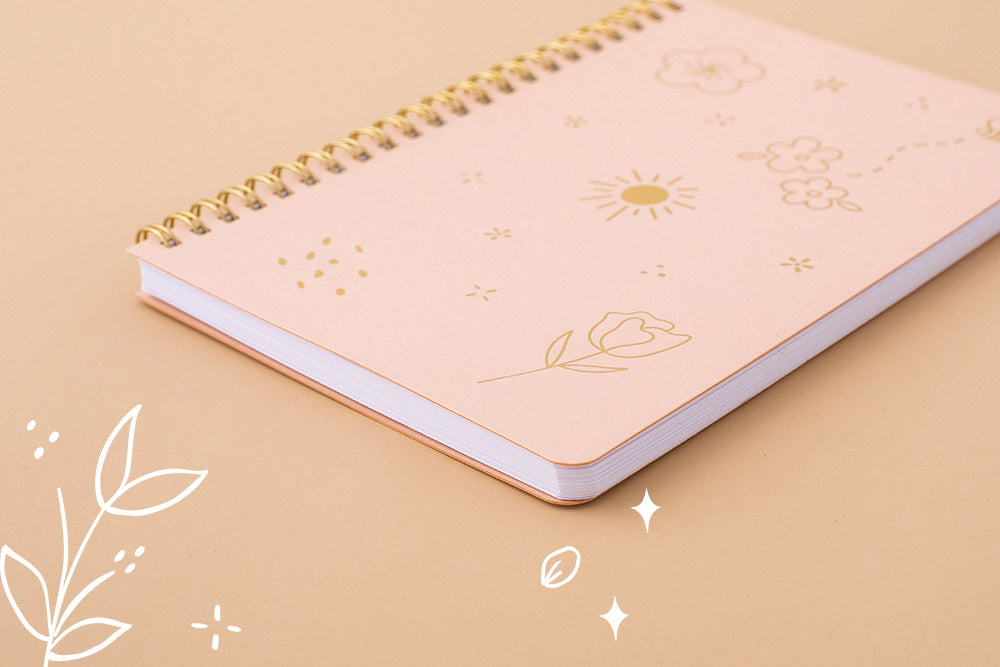 Tsuki Floral honey peach ringbound bujo laid on peach surface at an angle