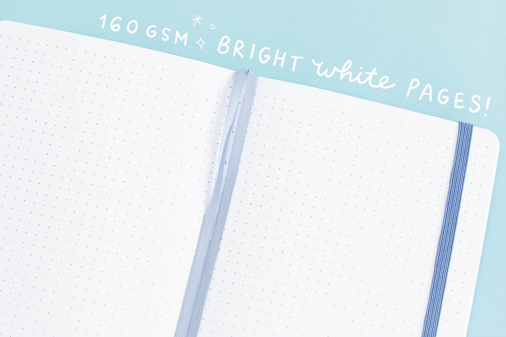 160gsm bright white bullet journal pages on a blue background