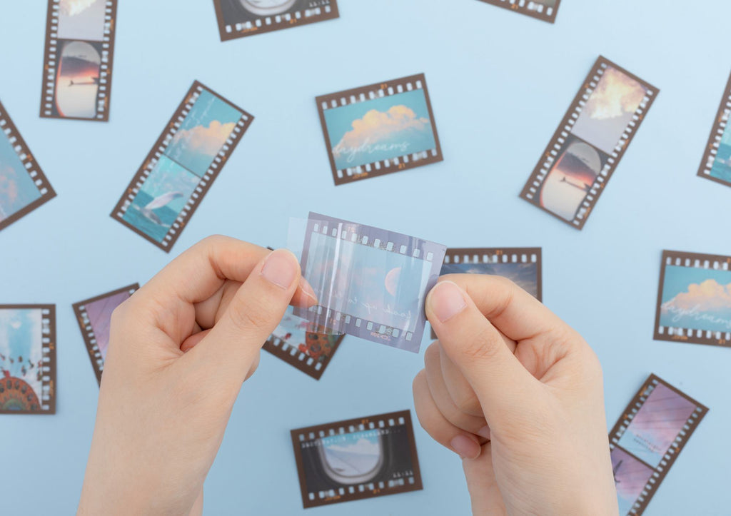 Hand holding a film strip stickers to show texture