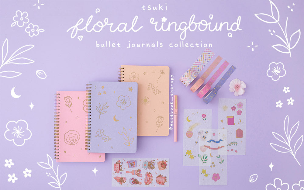 Tsuki Floral collection 3 ringbound bujo with washi tapes and sticker sheets laid out on lilac background with floral patterns