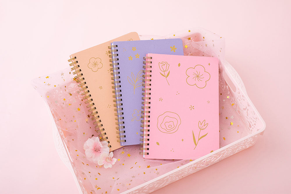 Tsuki Floral collection 3 ringbound bujo laid in pink basket on pink background