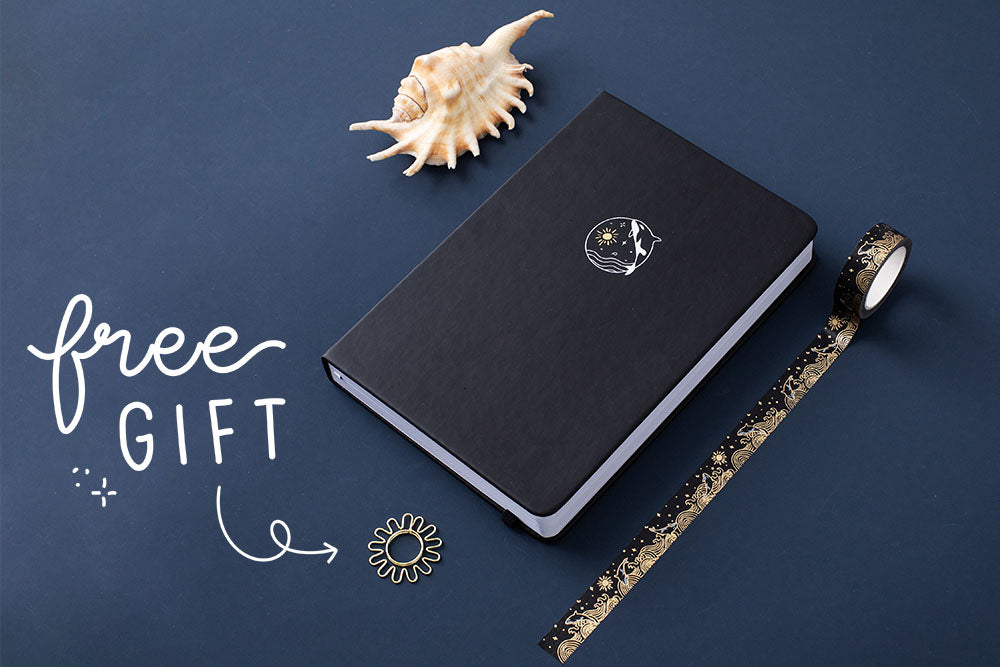 Tsuki deep black vegan leather Playful Orca limited edition notebook with seashells and Ocean washi tape with free gift on dark blue background