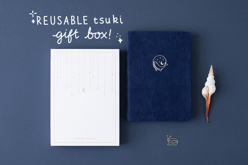 Tsuki deep blue Gentle Giant luxury edition notebook with eco-friendly reusable Tsuki gift box and seashell and free whale gift on dark blue background