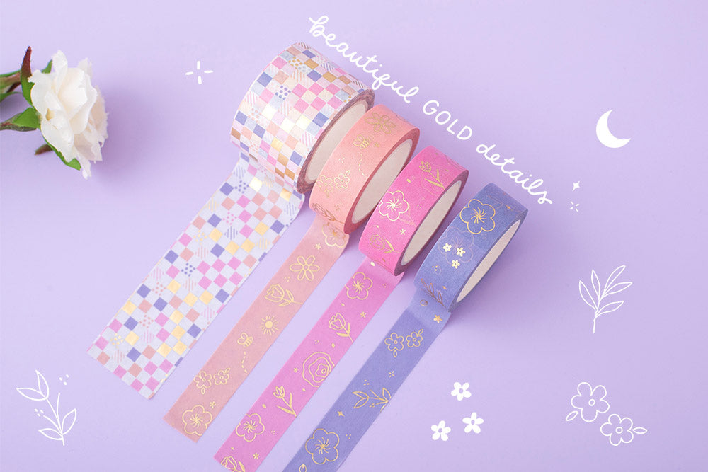 Tsuki Floral collection washi tapes with gold details rolled out on lilac background
