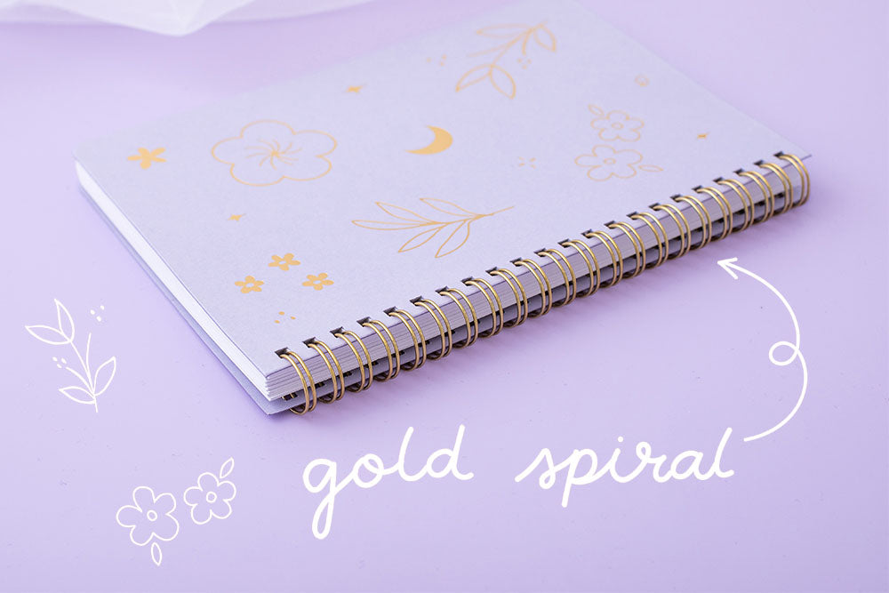 Gold Spiral facing lilac taro Floral ringboung notebook on lilac background