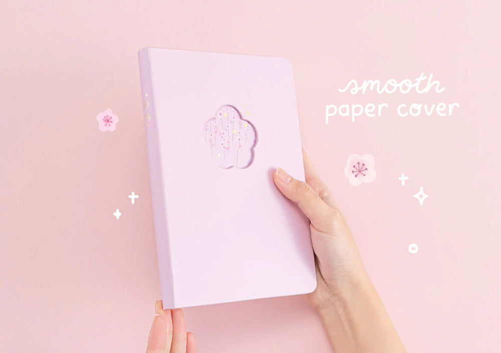 Tsuki Four Seasons: Spring Collector’s Edition 2022 Bullet Journal with soft vegan leather held in hands in light pink background