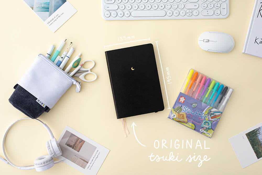 original tsuki size black softcover black bullet journal with souffle pens in creme background