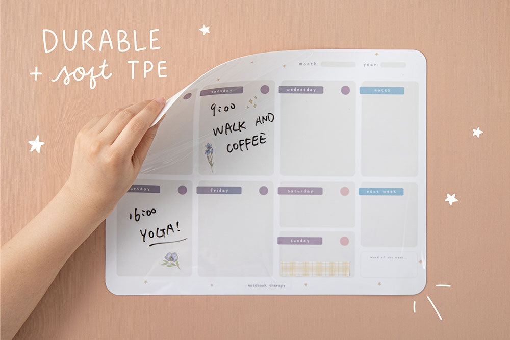 Tsuki Reusable Weekly Wall Planner with durable and soft TPE material held in hand on smooth wallpaper surface
