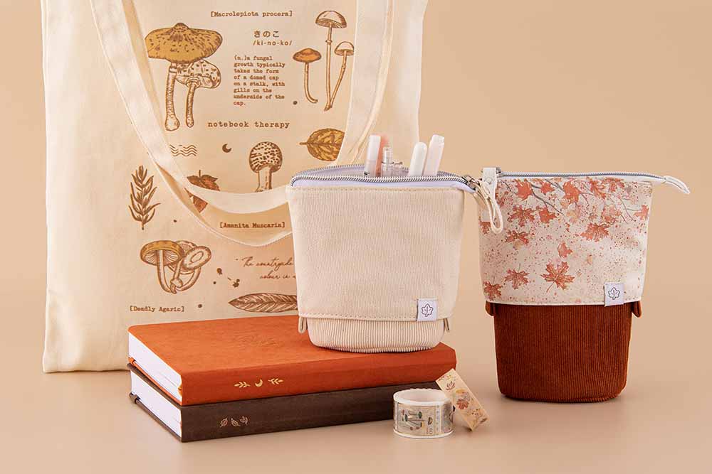 Tsuki ‘Maple Dreams’ Pop-Up Pencil cases in maple and stone with Tsuki ‘Vintage Kinoko’ Tote Bag and Tsuki ‘Maple Dreams’ Washi Tapes and Tsuki ‘Kitsune’ Limited Edition Fox Bullet Journal and Tsuki ‘Nara’ Limited Edition notebook in beige background