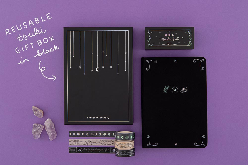 Tsuki ‘Moonlit Spell’ Limited Edition Holographic Bullet Journal with Tsuki ‘Moonlit Spell’ Washi Tape Set with black ink and black feather quill and amethyst stones on purple background