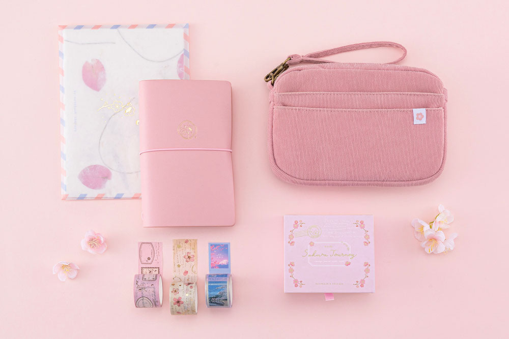 Tsuki ‘Sakura Journey’ Vintage Journal Washi Tape Set with Tsuki ‘Sakura Journey’ Limited Edition Travel Notebook and Tsuki ‘Sakura Journey’ Scrapbooking Set’ and Tsuki ‘Sakura Journey’ Travel Pouch with cherry blossoms on pink background