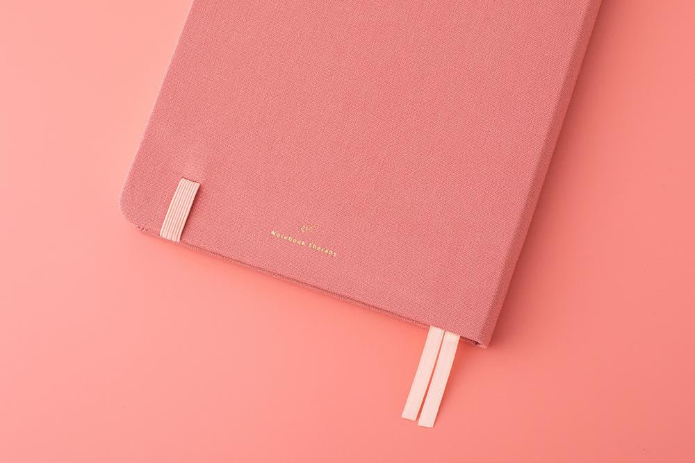 Close up of back cover of Tsuki ‘Suzume’ Limited Edition Bullet Journal on coral pink background