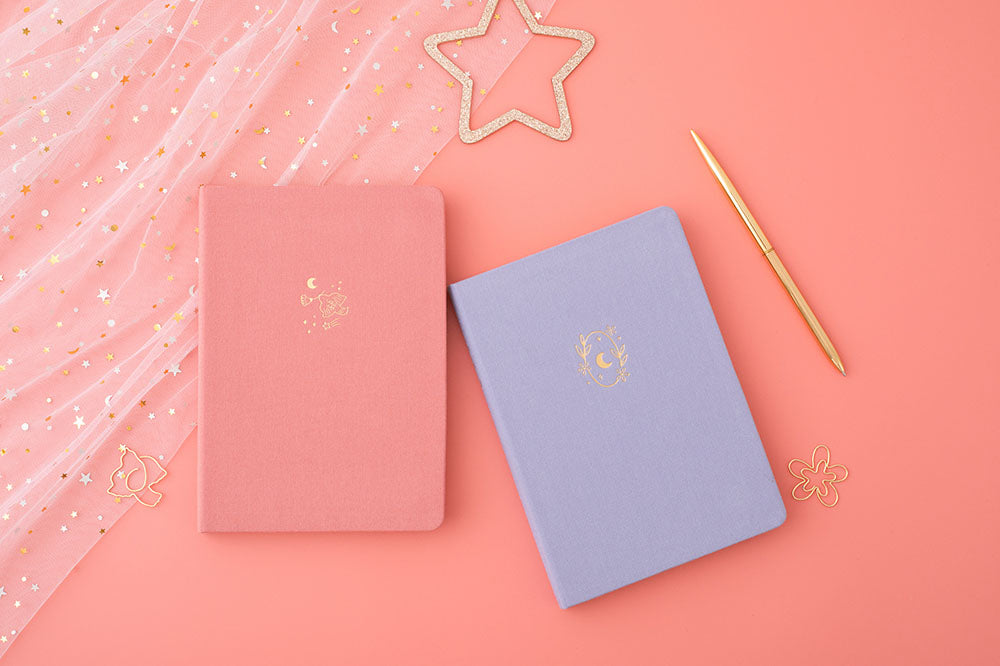Tsuki ‘Suzume’ Limited Edition Bullet Journal with ‘Full Bloom’ Limited Edition Notebook with star and netting and free gift and pen on coral pink background