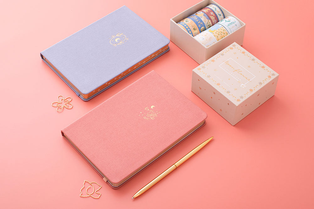 Tsuki ‘Full Bloom’ Limited Edition Bullet Journal with ‘Suzume’ Limited Edition Notebook and ‘Moonflower’ Washi Tape Set with pen on coral pink background