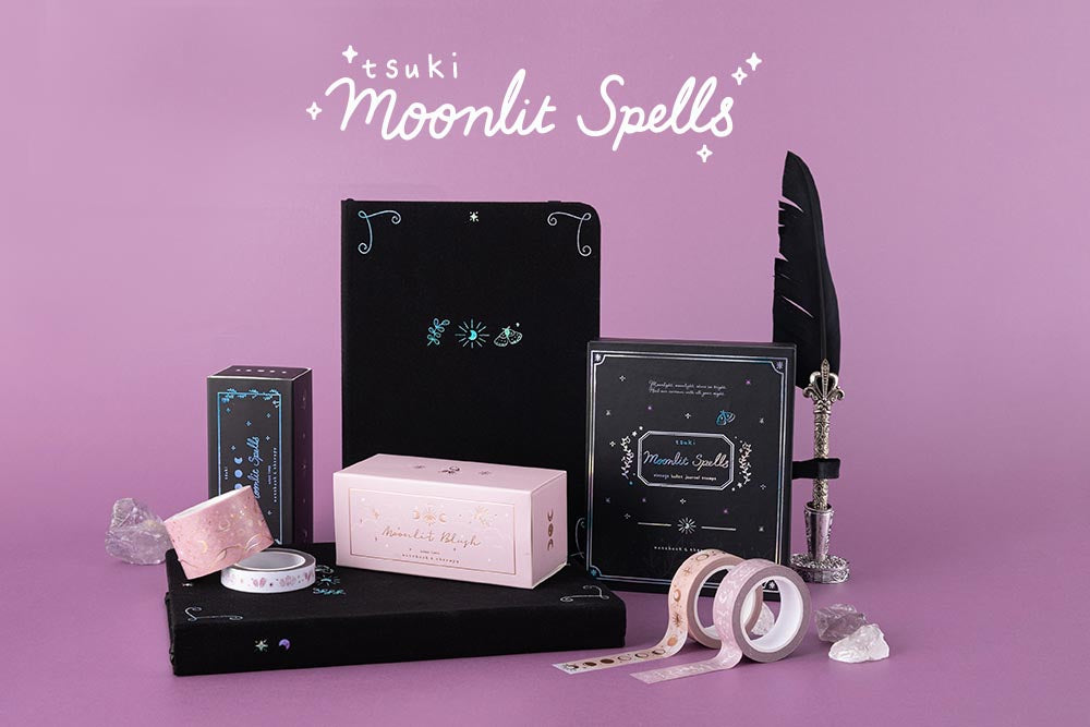 Tsuki Moonlit Spells Collection with quill pen and amethyst stones in purple background