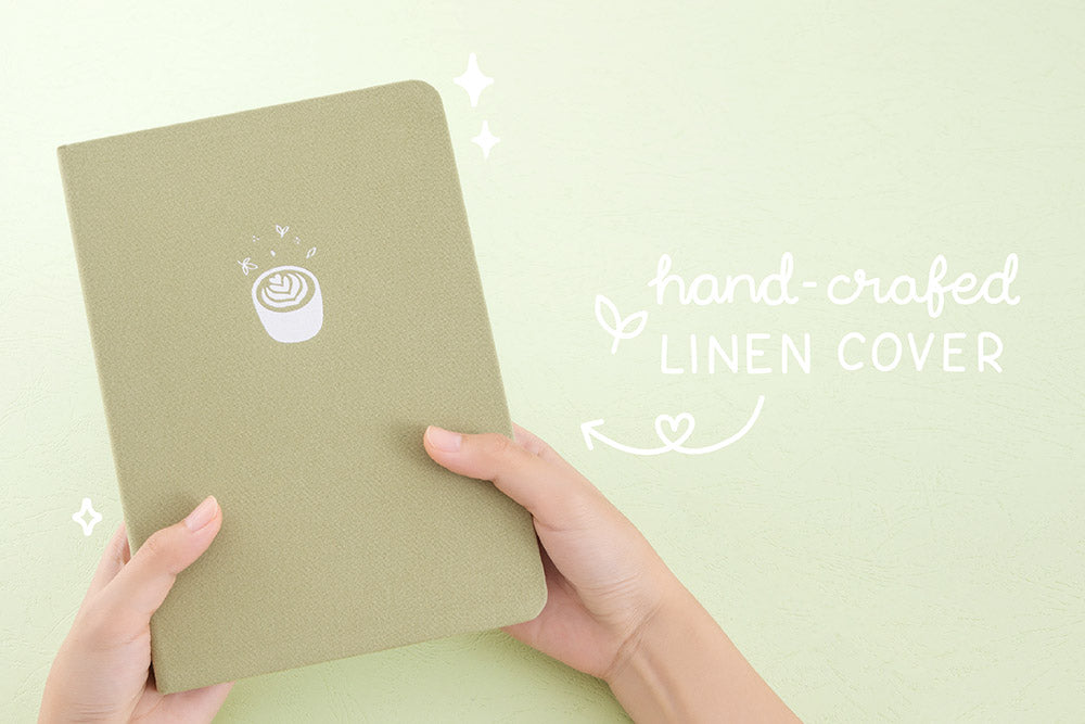 Tsuki ‘Matcha Matcha’ Limited Edition Bullet Journal with handcrafted linen cover held in hands in matcha green background