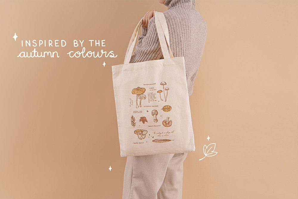 Tsuki ‘Vintage Kinoko’ Tote Bag inspired by the autumn colours held on model’s arm in beige background