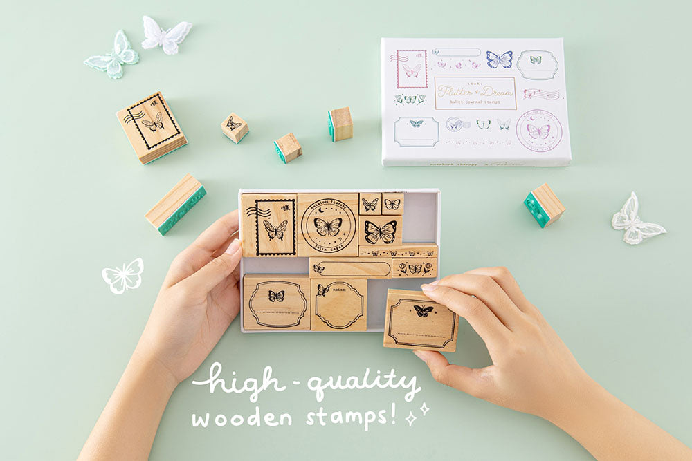 Tsuki ‘Flutter + Dream’ Bullet Journal Stamp Set by Notebook Therapy x Pelinkan with high quality wooden stamps held in hands with butterflies in mint background