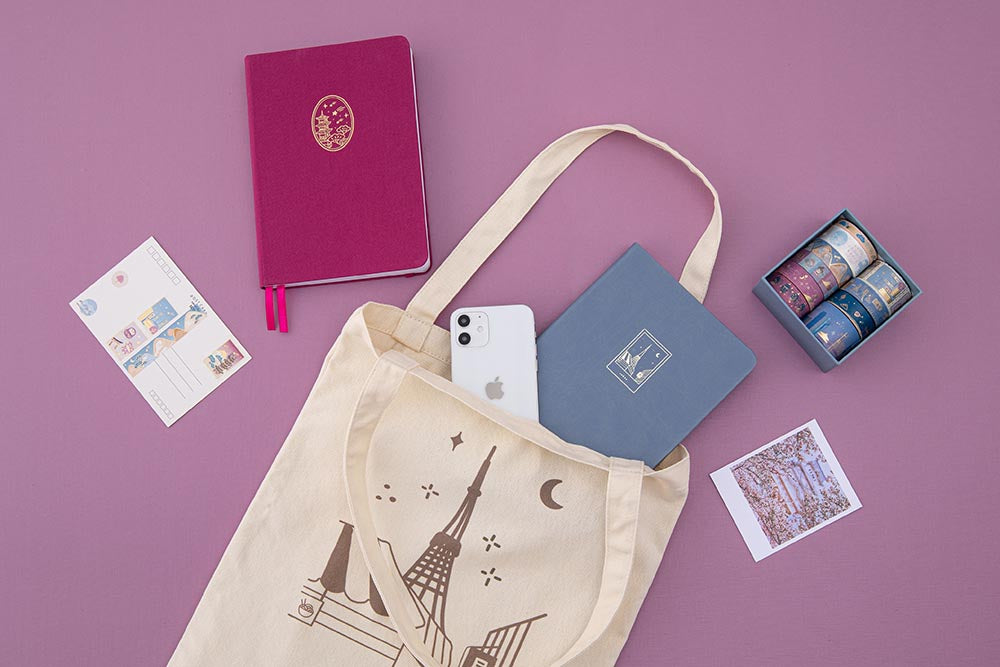 Tsuki Tokyo tote bag with a blue bullet journal notebook + an iPhone peeking out of the bag