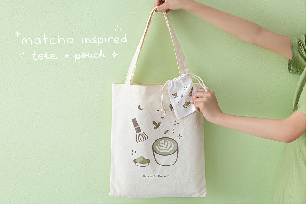 Tsuki ‘Matcha Matcha’ Tote Bag held in hands with free matcha inspired matching drawstring pouch in matcha green background