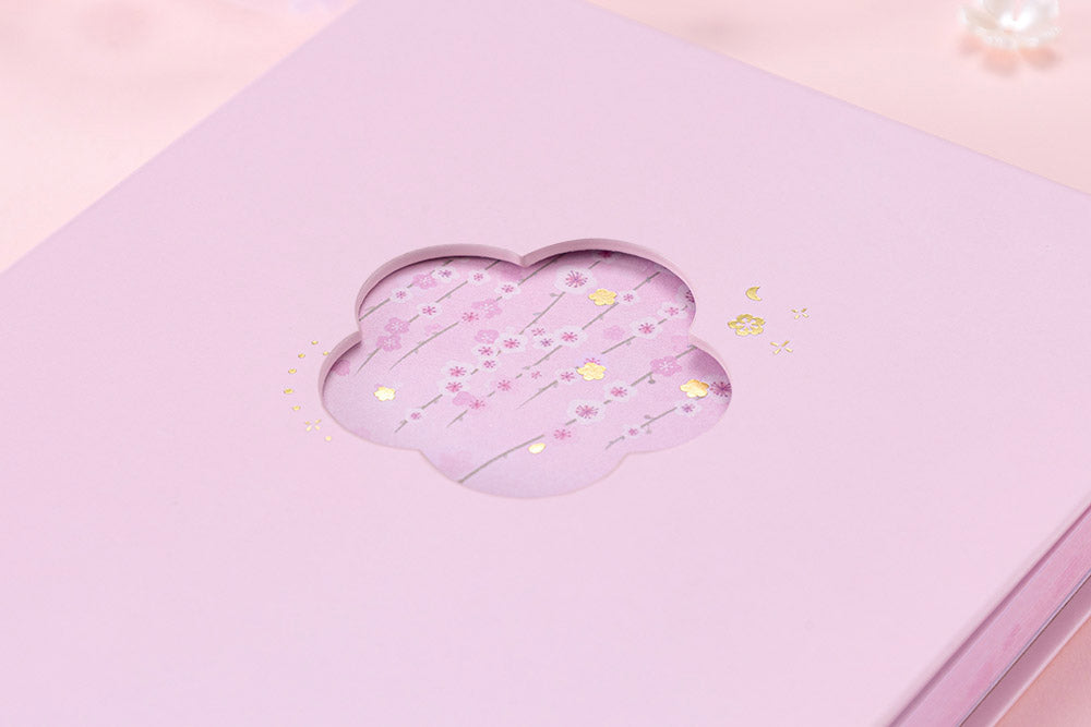 Close up of front cover of Tsuki Four Seasons: Spring Collector’s Edition 2022 Bullet Journal with flowers on light pink background