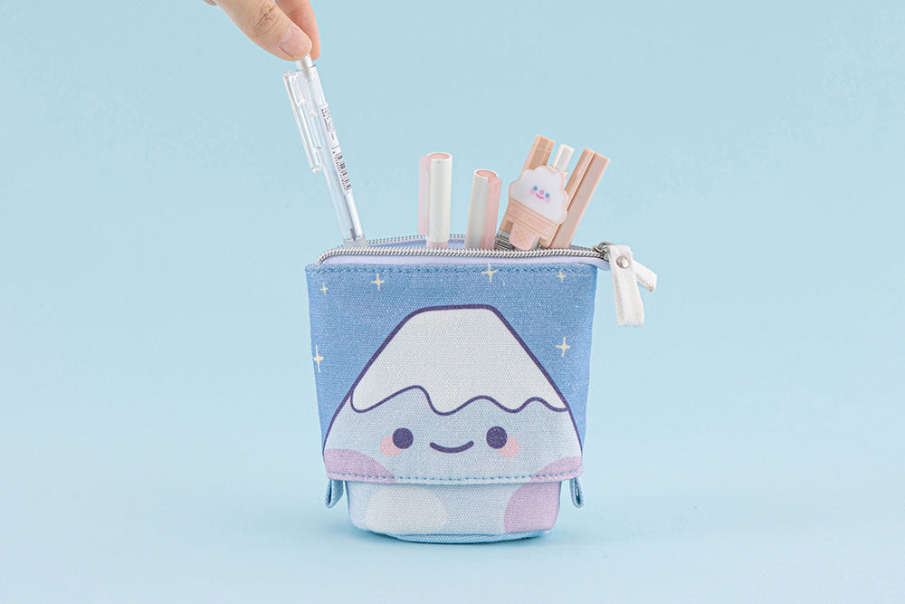 Tsuki ‘Four Seasons’ Fuji Pop-Up Pencil Case by Notebook Therapy x Milkkoyo with pen held in hand in light blue background