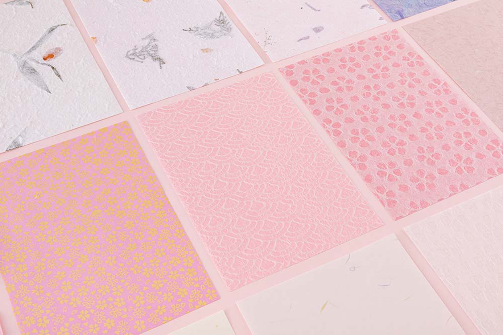 Close up of Tsuki ‘Sakura Journey’ Scrapbooking Set papers on pink background