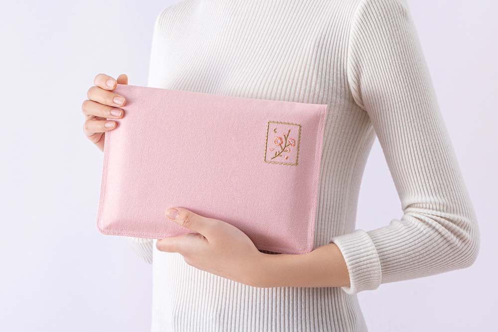 Tsuki ‘Sakura Journey’ Notebook Pouch held in arms by woman in white background