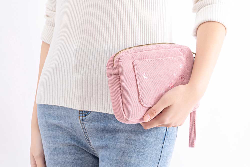 Tsuki ‘Sakura Journey’ Travel Pouch held in hands by model in white background