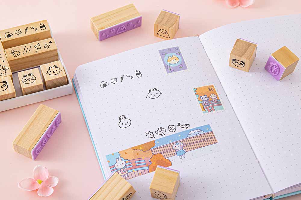 Tsuki ‘Four Seasons’ Bullet Journal Stamp Set by Notebook Therapy x Milkkoyo on open bullet journal page spread with Tsuki ‘Four Seasons’ Washi Tapes with pink flowers on petal pink background