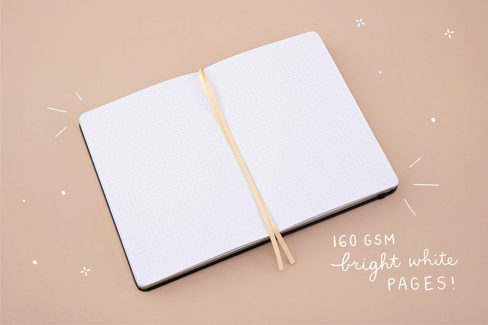 Open page spread of Tsuki ‘Moonlit Wish’ Limited Edition Bullet Journal with 160GSM bright white pages on light brown background