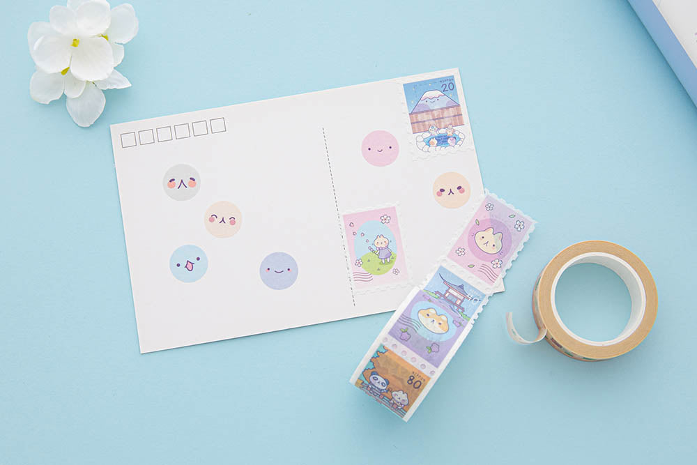 Tsuki ‘Four Seasons’ Stamp and Circle Washi Tapes by Notebook Therapy x Milkkoyo on white postcard with white flower on light blue background
