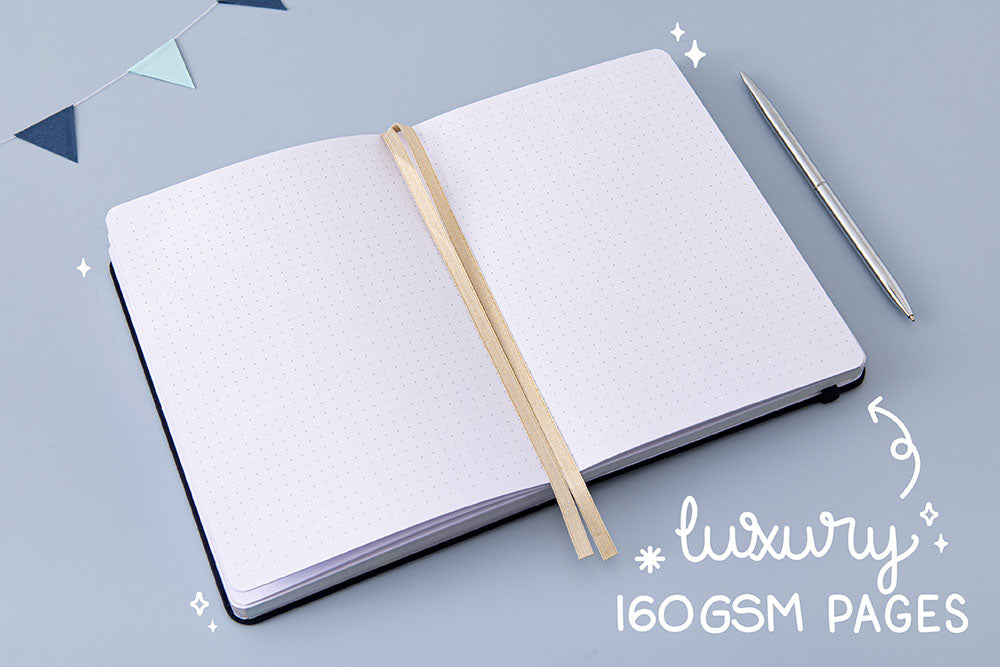 Tsuki ‘Cup of Galaxy’ Limited Edition Holographic Bullet Journal with two bookmark ribbons and luxury 160GSM pages with silver pen and bunting on light blue background