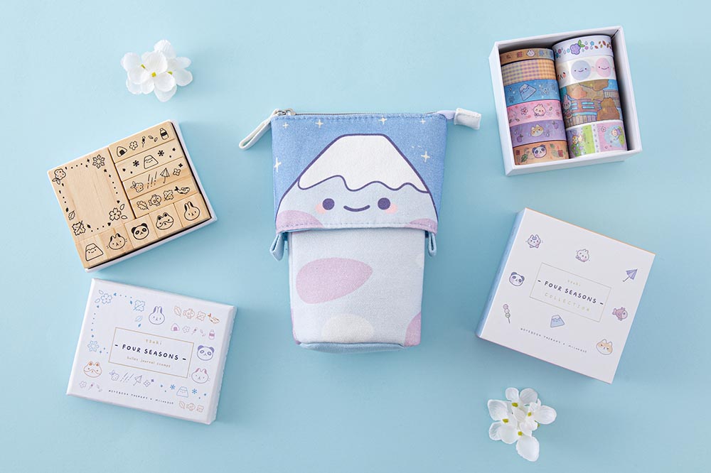 Tsuki ‘Four Seasons’ Fuji Pop-Up Pencil Case by Notebook Therapy x Milkkoyo with Tsuki ‘Four Seasons’ Washi Tape Set and Tsuki ‘Four Seasons: Bullet Journal Stamp Set with white flowers on light blue background