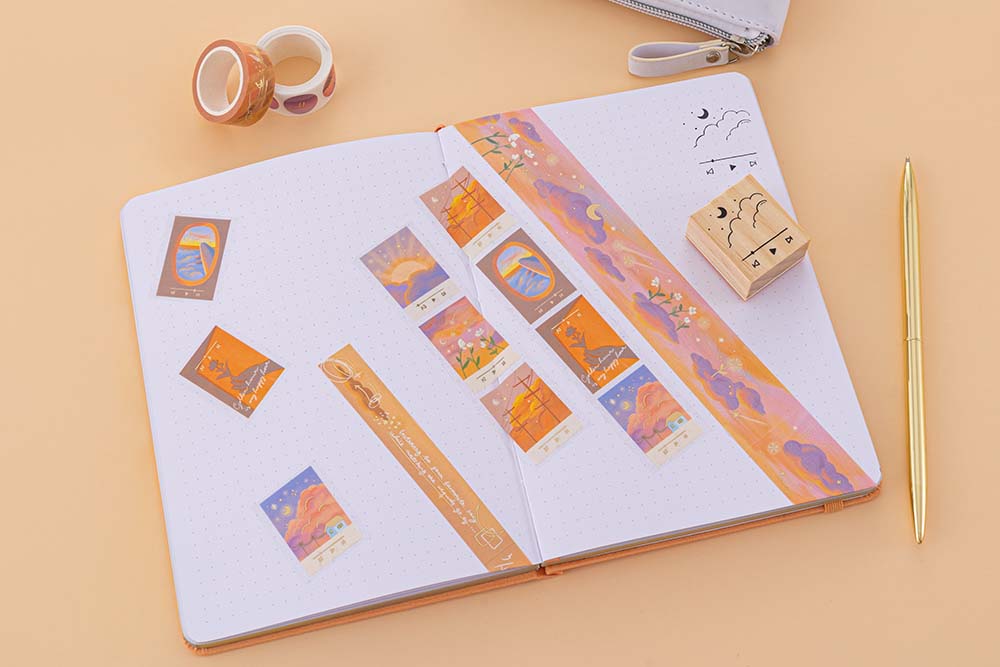 Washi tapes and playlist stamp on bullet journal on an orange background
