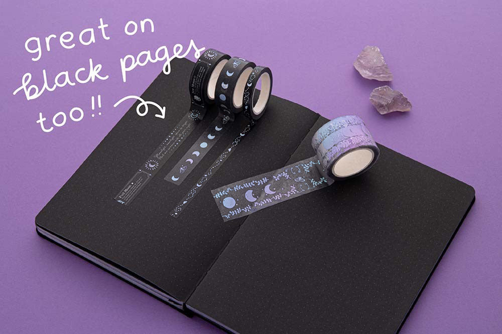 Tsuki ‘Moonlit Spell’ Washi Tapes great on open Tsuki ‘Moonlit Spell’ Limited Edition black page holographic bullet journal with amethyst stones on purple background