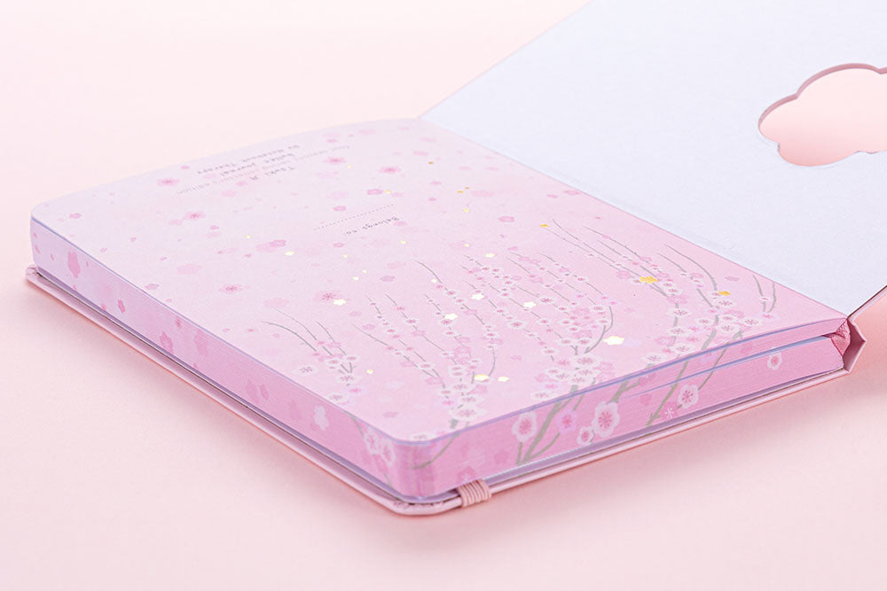 Open front page of Tsuki Four Seasons: Spring Collector’s Edition 2022 Bullet Journal on light pink background