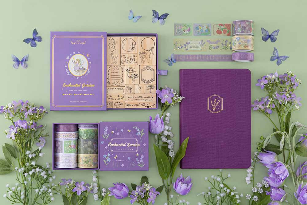 Tsuki ‘Enchanted Garden’ collection on sage green background with purple flower and butterfly decoration
