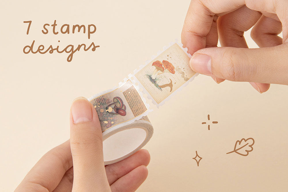 Tsuki ‘Maple Dreams’ stamp Washi Tape with seven stamp designs held in hands in cream background