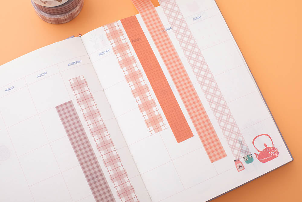 Tsuki Core Washi Tape Set in Warm Neutral on open bullet journal page on orange peach background