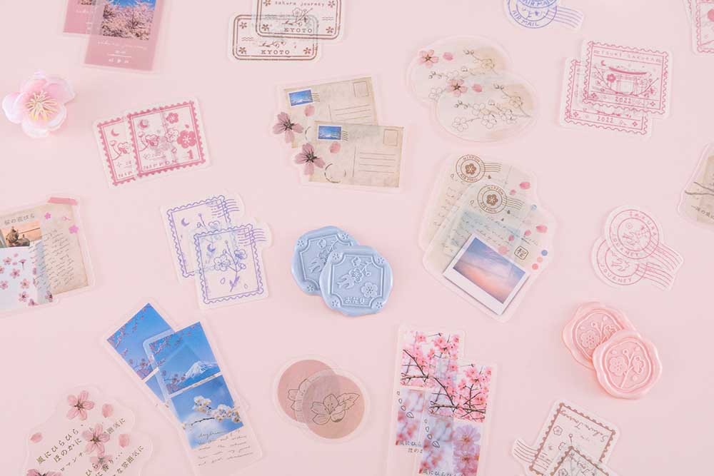 Wax seal stickers and sticker flakes from Tsuki ‘Sakura Journey’ Scrapbooking Set on pink background