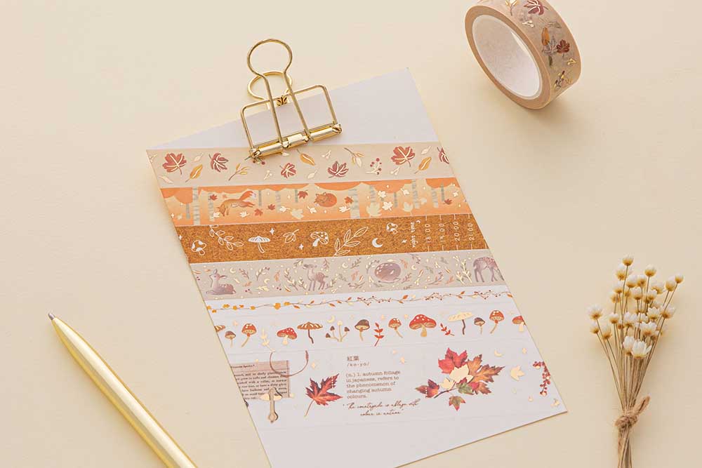 Tsuki ‘Maple Dreams’ Washi Tapes on bright white clipboard with gold pen and dried flowers on cream background