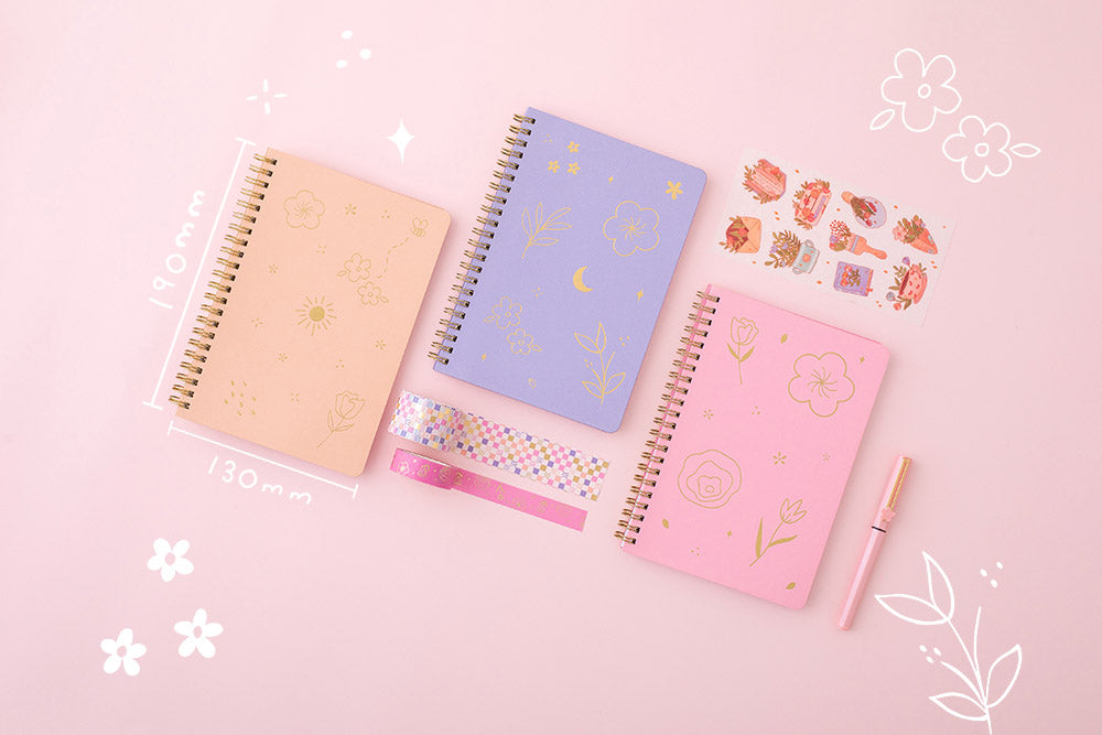 Tsuki Floral collection 3 ringbound bujo laid out with sticker sheet and washi tapes, on pink background