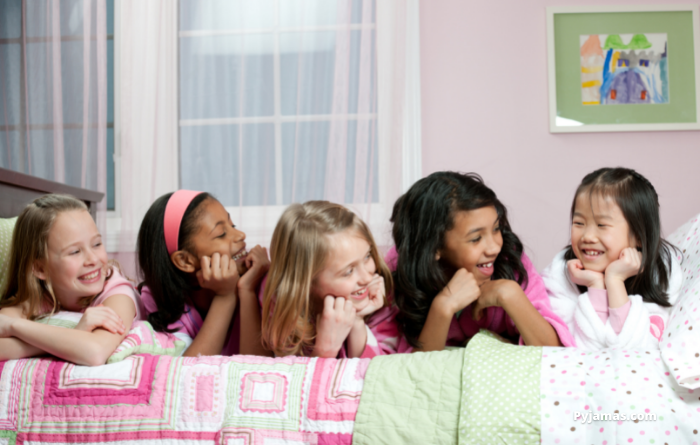 Tween girls on bed at sleepover