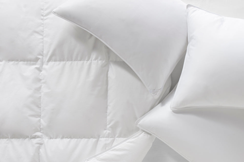 white goose down duvet and pillows on bed