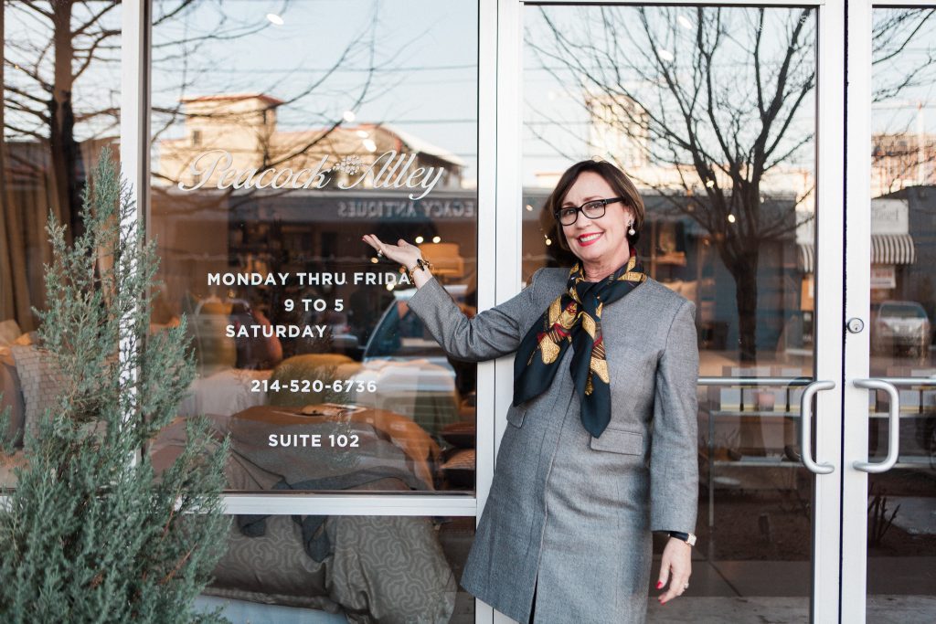 Margaret Chambers posing in front of a Peacock Alley store window